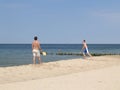 Two men play beach tennis on the sandy coast of the Baltic Sea