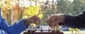 Two men play chess on a sunny autumn day in the park. Royalty Free Stock Photo