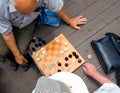 Two men playing chess stenographed by top view