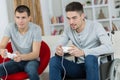 Two men playing computer game one in wheelchair