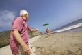 Two men playing with flying disc on beach Royalty Free Stock Photo