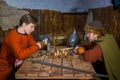 Two men playing popular strategy board game - tafl