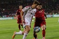 two men playing soccer on a field in front of a crowd Royalty Free Stock Photo