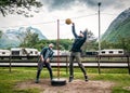 Two men are playing tetherball game