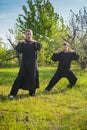 Two men practice tai Chi in a garden Royalty Free Stock Photo