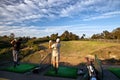 Two men practicing their golf swing at a driving range Royalty Free Stock Photo