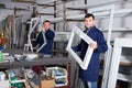 Two men professional labours with finished PVC profiles and windows Royalty Free Stock Photo