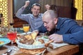 Two men in a restaurant arguing during lunch Royalty Free Stock Photo