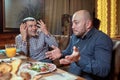 Two men in a restaurant arguing during lunch Royalty Free Stock Photo