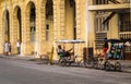 Two men resting on their bicycle taxis