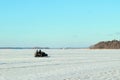 Two men riding on a snowmobile winter