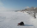 Two men riding on a snowmobile winter river. Russia, Saratov - january, 2016 Royalty Free Stock Photo