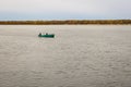 Two men in a rowing boat float along the river Royalty Free Stock Photo