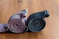 Two men`s ties, rolled up on a wooden background Royalty Free Stock Photo