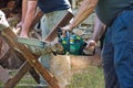 Two men sawing wood using motor saw Royalty Free Stock Photo