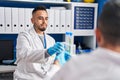 Two men scientists holding test tubes at laboratory