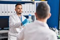 Two men scientists holding test tubes at laboratory