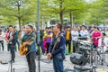 Two men of Shenzhen local street band palying guitar and singing at the Central park of Shenhzhen