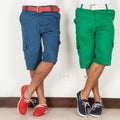 Two men in shorts green and blue colors on white background Royalty Free Stock Photo