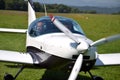 Two men sit into ultralight propeller-driven airplane and get ready for taking off