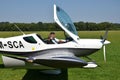 Two men sit into ultralight propeller-driven airplane and get ready for taking off