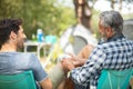 two men sitting on soft chair at camp site Royalty Free Stock Photo