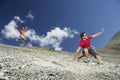 Two Men Sliding Down Scree Field Royalty Free Stock Photo