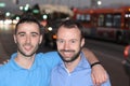 Two men smiling walking the city streets at night Royalty Free Stock Photo
