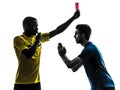 Two men soccer player and referee showing red card silhouette Royalty Free Stock Photo