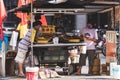 two men stand by the food vendor on the street corner