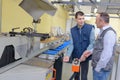 Two men stood by factory producation line Royalty Free Stock Photo