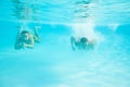 Two men swimming under water