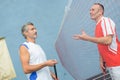 Two men talking through badmington net Royalty Free Stock Photo
