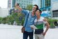 Two men tourists taking selfie photo smile, asian