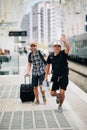 Two man traveler miss or late on train and running after train on platform on railway station. Travel concept Royalty Free Stock Photo