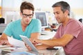 Two Men Using Tablet Computer In Creative Office Royalty Free Stock Photo