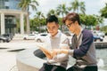 Two Men Using Tablet Computer Internet, Asian Friends Guys Sitting at Cafe Natural Light Royalty Free Stock Photo