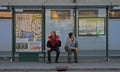 Two men are waiting transport at the bus stop Royalty Free Stock Photo