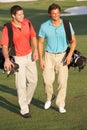 Two Men Walking Along Golf Course Royalty Free Stock Photo