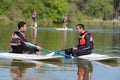 Two men wearing wetsuits sat on paddle boards Royalty Free Stock Photo