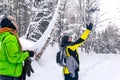 Two men in the winter forest launch a quadcopter