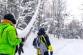 Two men in the winter forest launch a quadcopter