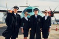 Two men and two women. Crew of airport and plane workers in formal clothes standing outdoors together Royalty Free Stock Photo