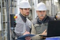 Two men working with laptop in factory Royalty Free Stock Photo