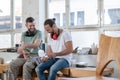 Two worker in a carpenter`s workshop taking a break Royalty Free Stock Photo