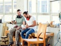 Two worker in a carpenters workshop taking a break Royalty Free Stock Photo