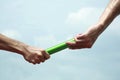 Two men& x27;s hands passing the baton in a relay race. Conceptual image Royalty Free Stock Photo