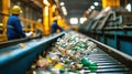 Two Men in Yellow Jackets and Orange Hats Sorting Plastic Bottles at a Garbage Processing Plant Royalty Free Stock Photo