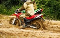 Two mens on a motorcycle rides through the mud Royalty Free Stock Photo