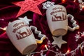 Two Merry Christmas cups on red blanket with lights and decorations Royalty Free Stock Photo